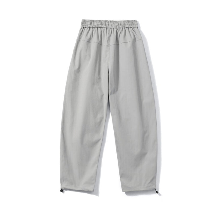 Men's utility cargo pants with elastic waistband, zip pocket, and adjustable hem.
