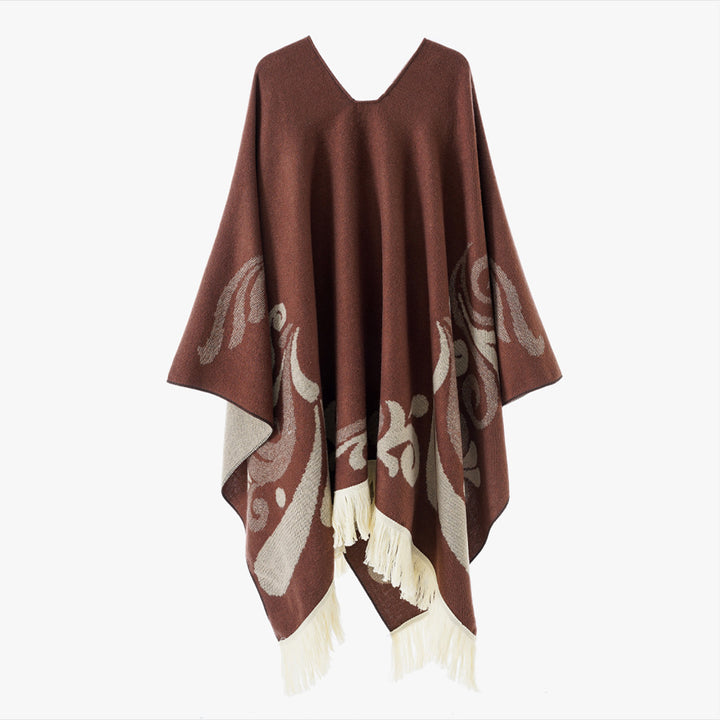 Women's wool blend poncho in cape style with V-neck, contrasting ornament jacquard and fringes.