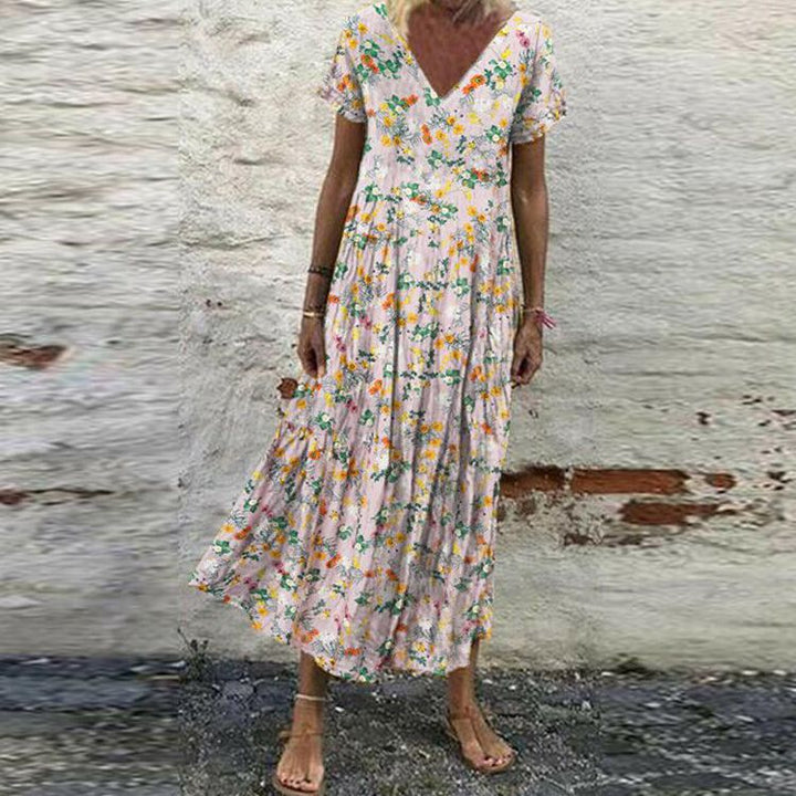 Women’s V-neck maxi dress with fine pleated skirt, empire bodice and short sleeves Mune Fashion