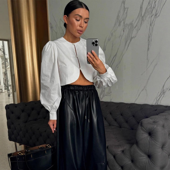 Women short-cut blouse with curved hem edge and voluminous puff sleeves Mune Fashion