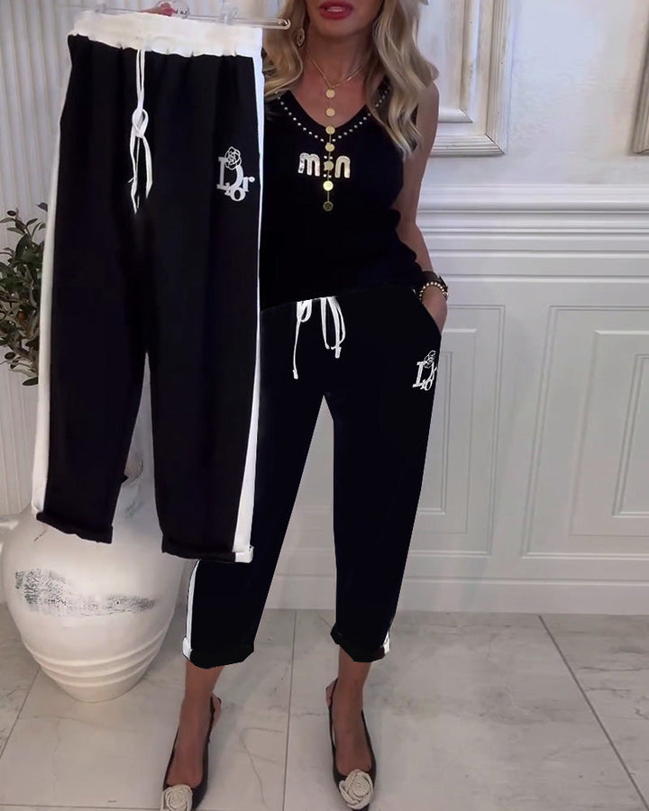 Women's Cropped Jogging Pants with contrasting waistband, side decorative stripe, drawstring, and logo embroidery Mune Fashion