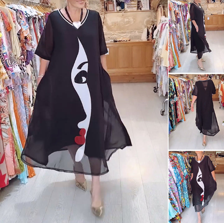 Women's airy chiffon maxi dress with graphic face print, V-neck and side pockets Mune Fashion