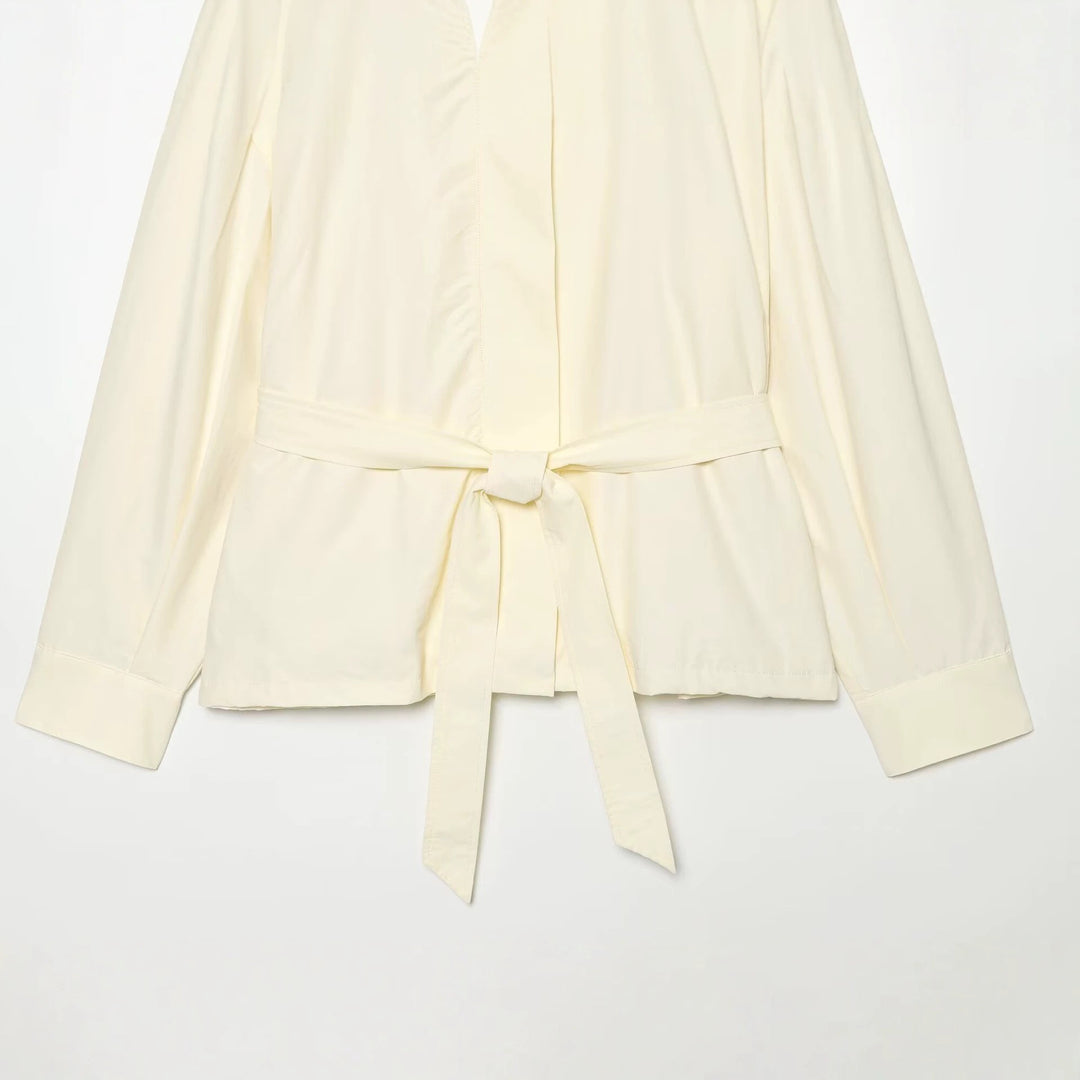 Women's short jacket made of flowing fabric with waist belt and cape shoulder drape