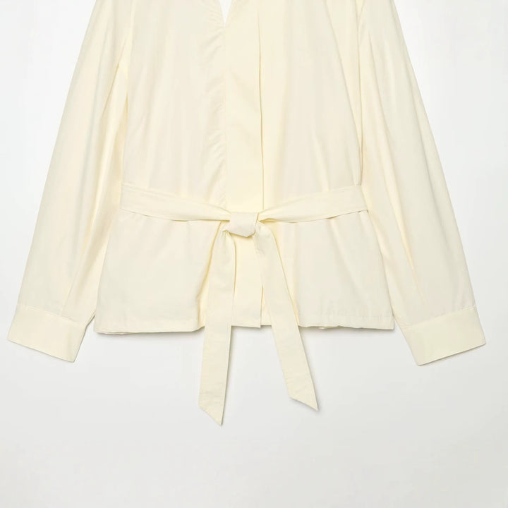 Women's short jacket made of flowing fabric with waist belt and cape shoulder drape