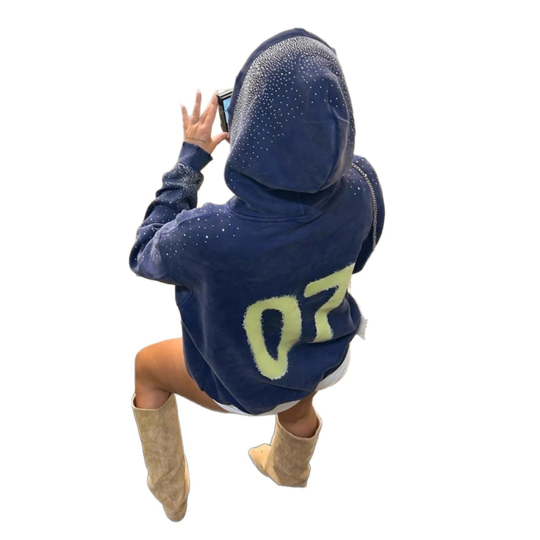 Women's oversized hoodie made of velvet fleece with distinctive logo print, glitter trim, and kangaroo pocket Mune Fashion