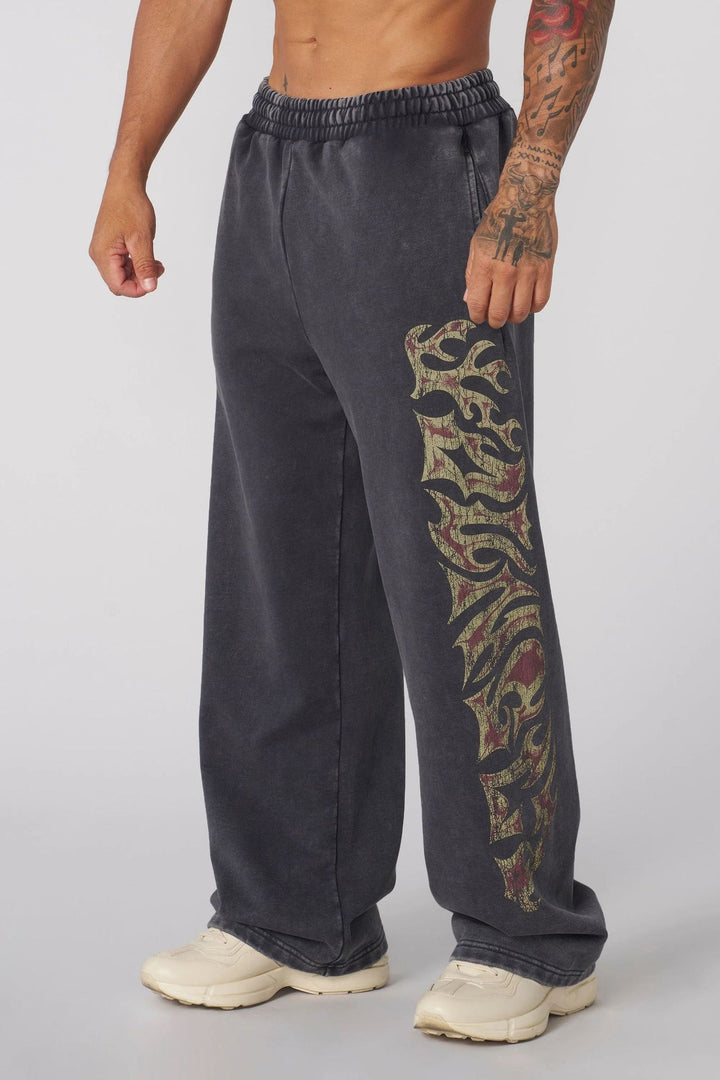 Men's baggy joggers with elastic waistband, side pockets and detailed skull and rose motif Mune Fashion