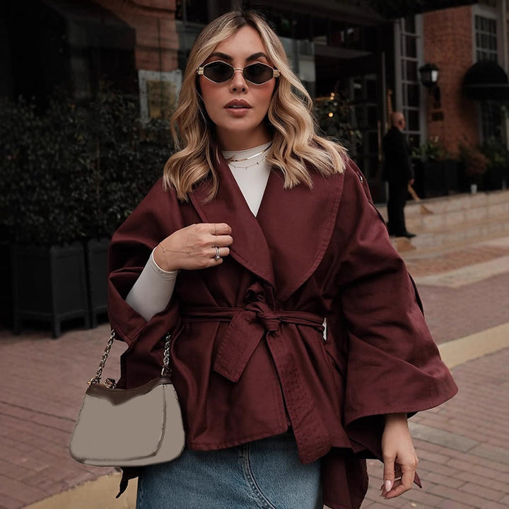 Women's short trench-style jacket with belted waist, oversized sleeves, and boxy cropped silhouette Mune Fashion