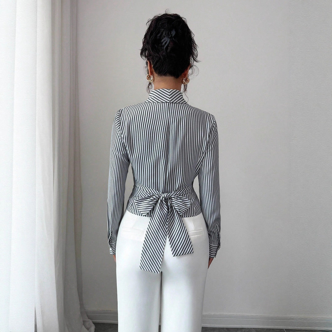 Women's fitted wrap blouse with lapel collar and decorative metal buckle Mune Fashion