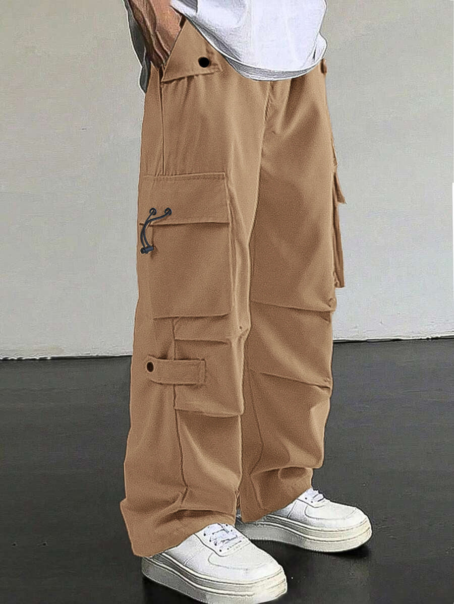 Men's baggy cargo pants with utilitarian flap pockets, drawstring waistband, and reinforced seams Mune Fashion