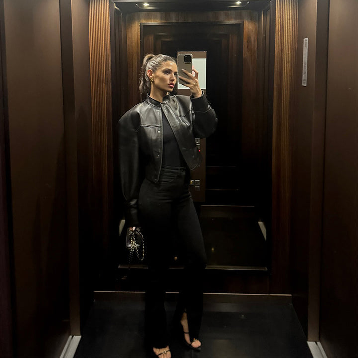 Women's short jacket made of vegan smooth leather with prominent shoulder pads and concealed snap button placket Mune Fashion