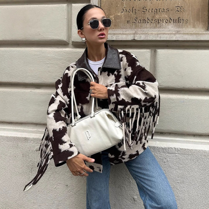 Ladies short jacket in cow print with fringes, faux fur look and leather collar Mune Fashion