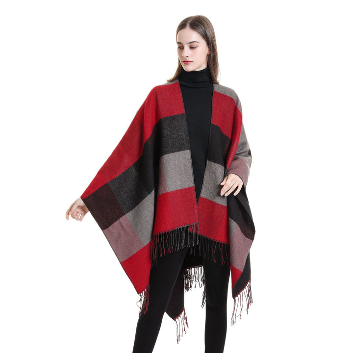 Women’s web cape in a boxy ruana cut with diagonal check pattern and fringes