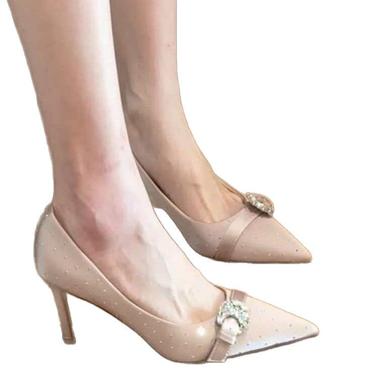 Ladies patent pumps with pointed toe, rhinestone buckle, and mid-high stiletto heel