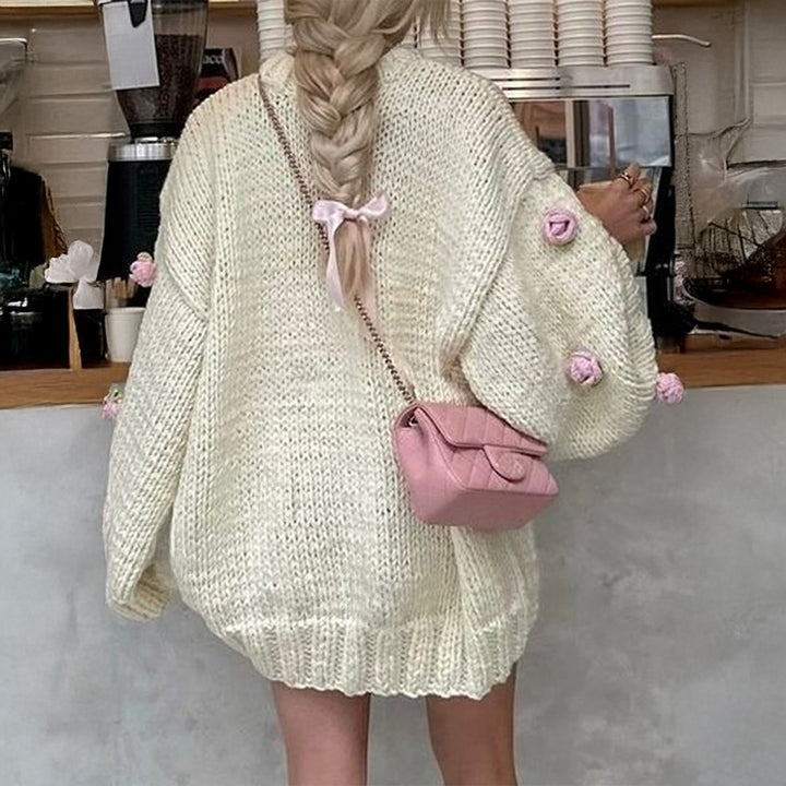 Women's oversized knit sweater with 3D floral appliqués and wide trumpet sleeves Mune Fashion