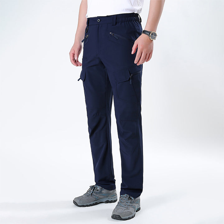 Men's nano technical trekking pants with elastic waistband, pre-shaped knees, and multiple cargo and zip pockets.