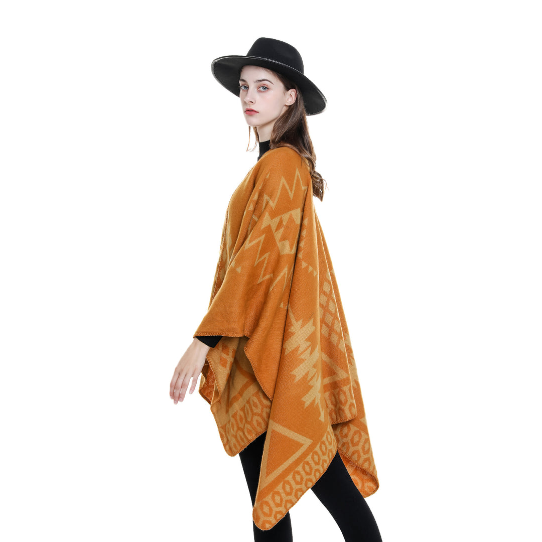 Women's oversized Ruana poncho with cashmere touch, geometric jacquard, and open kimono silhouette.