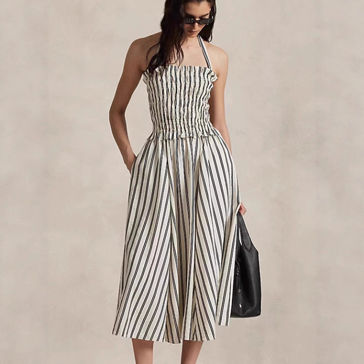 Women's midi dress with smocked bodice, adjustable halter strap, wide A-line skirt and side pockets Mune Fashion