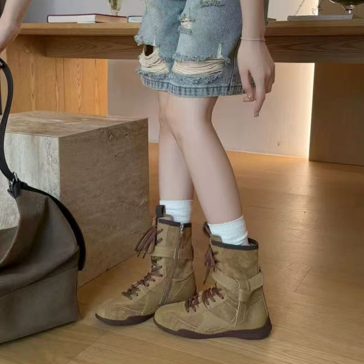 Ladies lace-up ankle boots with decorative contrasting stitching, strap closure and distinctive tread sole Mune Fashion