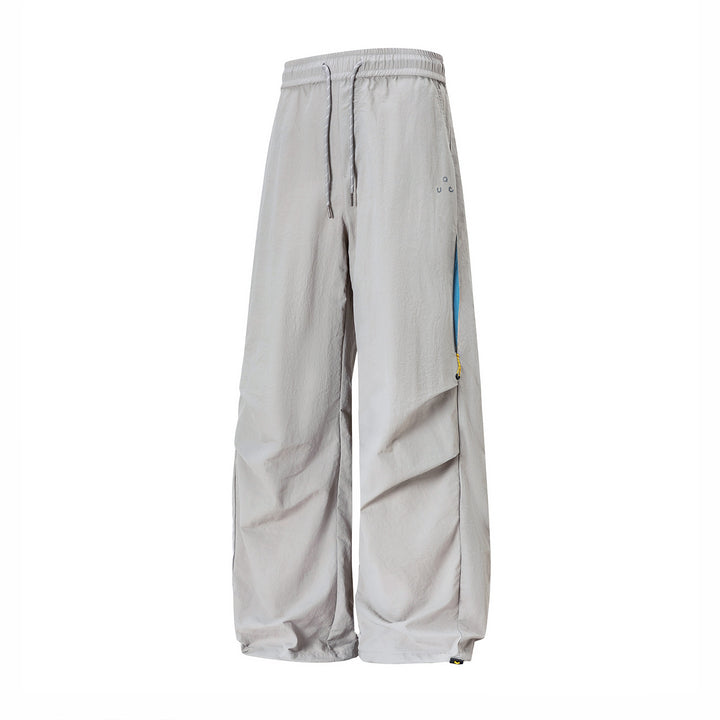 Unisex wide technical cargo pants with drawstring waistband, zip pockets, and adjustable hem Mune Fashion