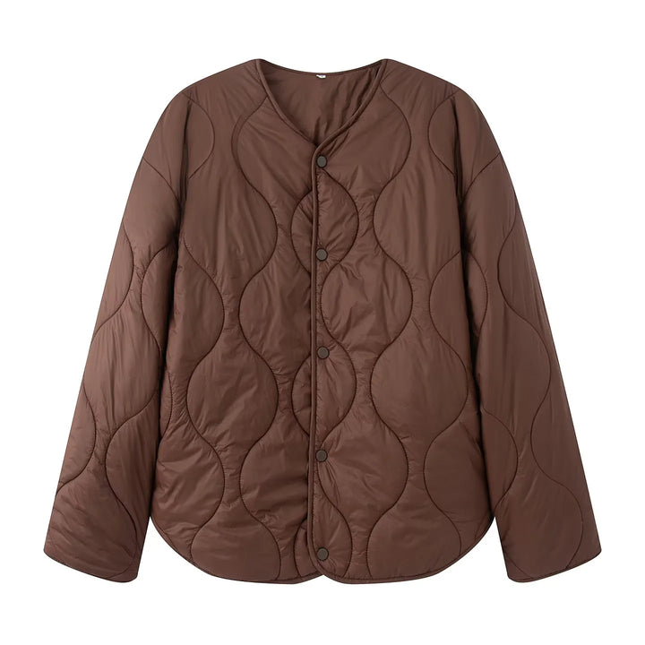 Women's quilted transition jacket with round neckline, snap button closure, and curved hem Mune Fashion