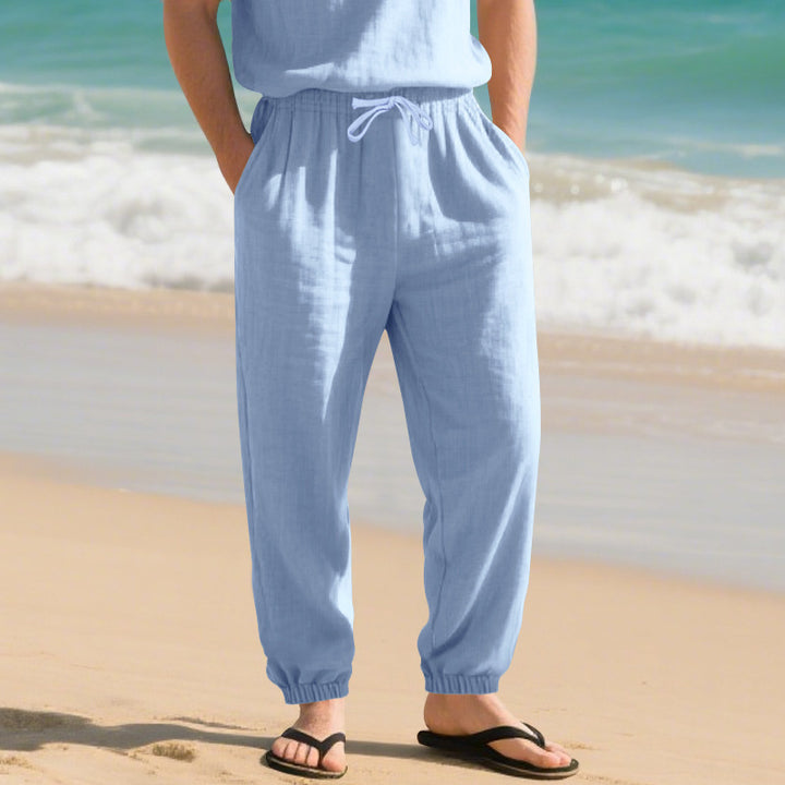 Men's light linen pants with elastic tunnel drawstring waistband, side pockets, and smocked cuffs Mune Fashion