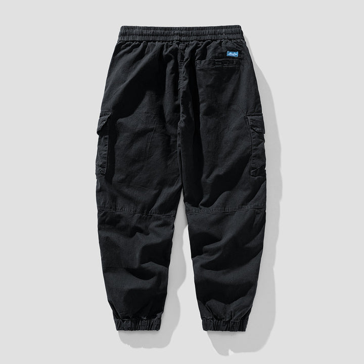 Herren Leichte Canvas-Cargohose im Joggerstil mit elastischem Bund, segmentierten Kniepaneelen und verdeckten Klappentaschen Mune Fashion