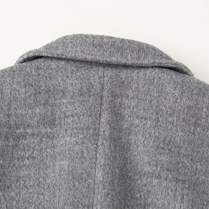 Women's short blazer coat made of wool blend with lapel collar, two-button closure, and patch pockets Mune Fashion