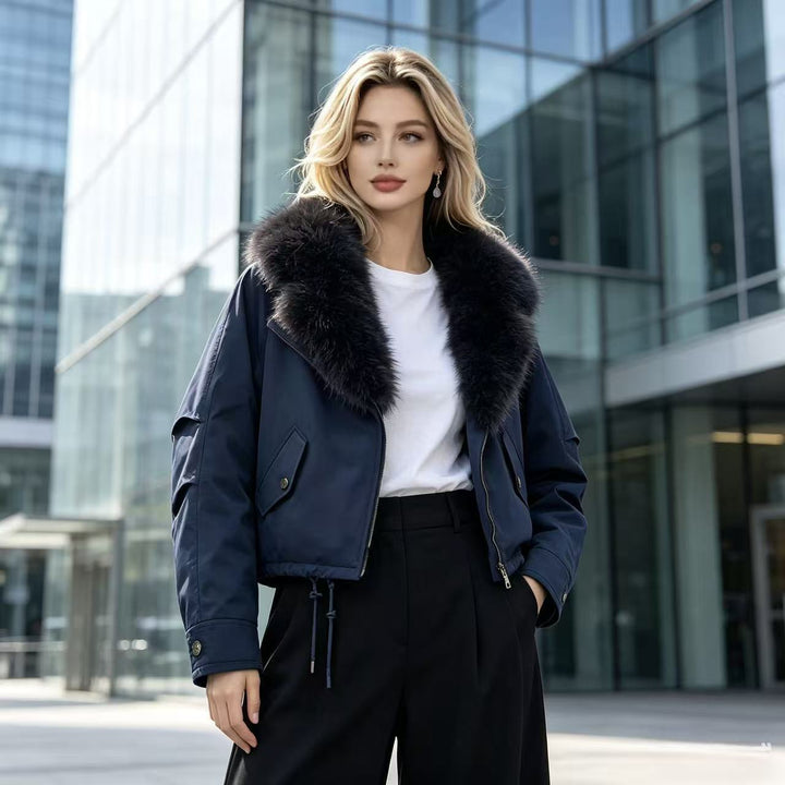 Women's short bomber jacket with voluminous faux fur collar, drawstring hem, and flap pockets Mune Fashion