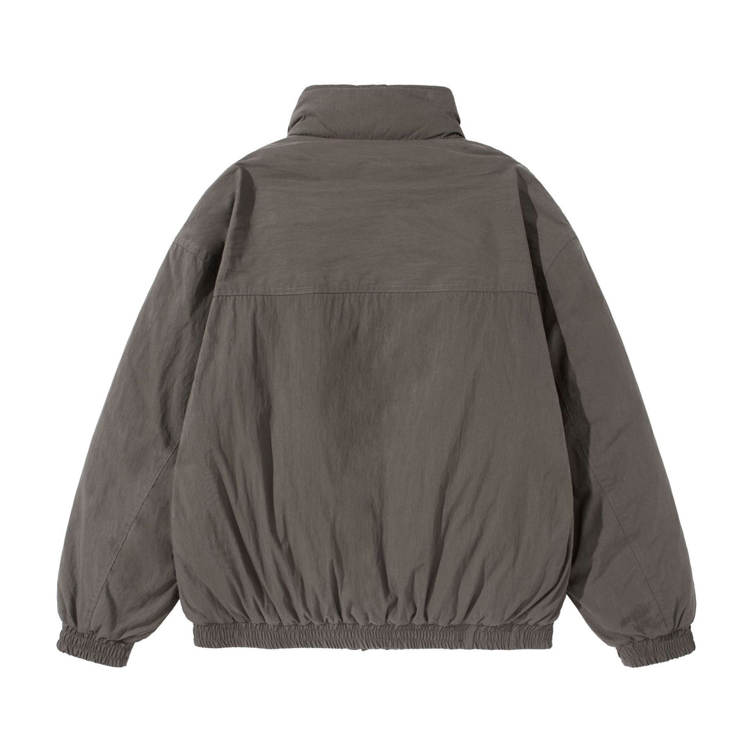 Unisex Short-cut quilted boxy blouson jacket with high stand-up collar and utility flap pockets Mune Fashion