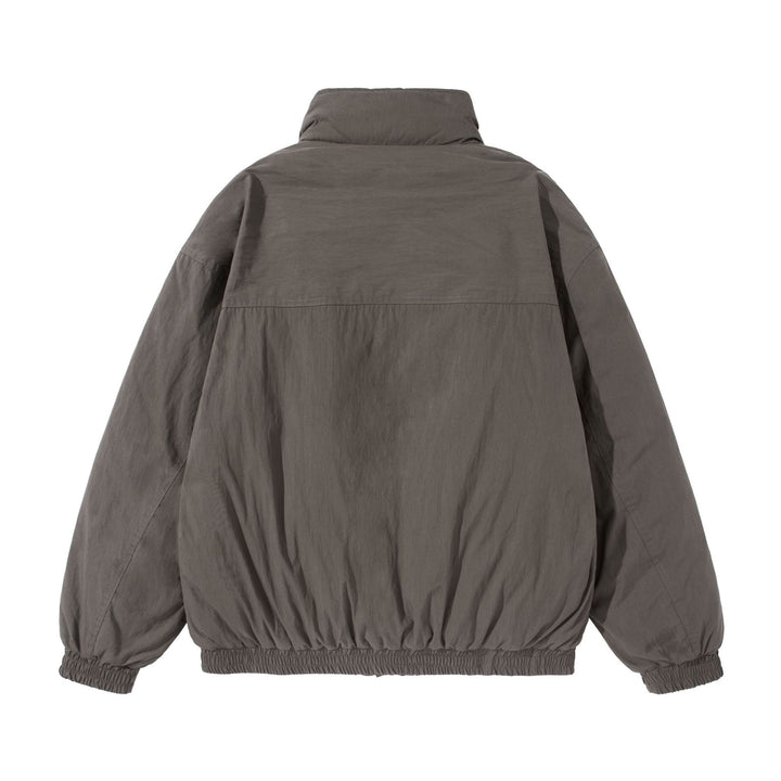 Unisex Short-cut quilted boxy blouson jacket with high stand-up collar and utility flap pockets Mune Fashion