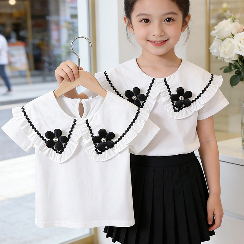 Girl's blouse with ruffled hem and floral design Mune Fashion