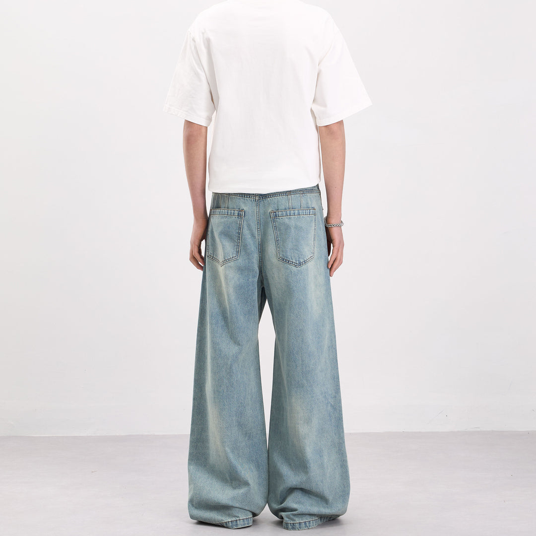 Men's wide-cut denim palazzo pants with curved seam panels and extra-long hem Mune Fashion