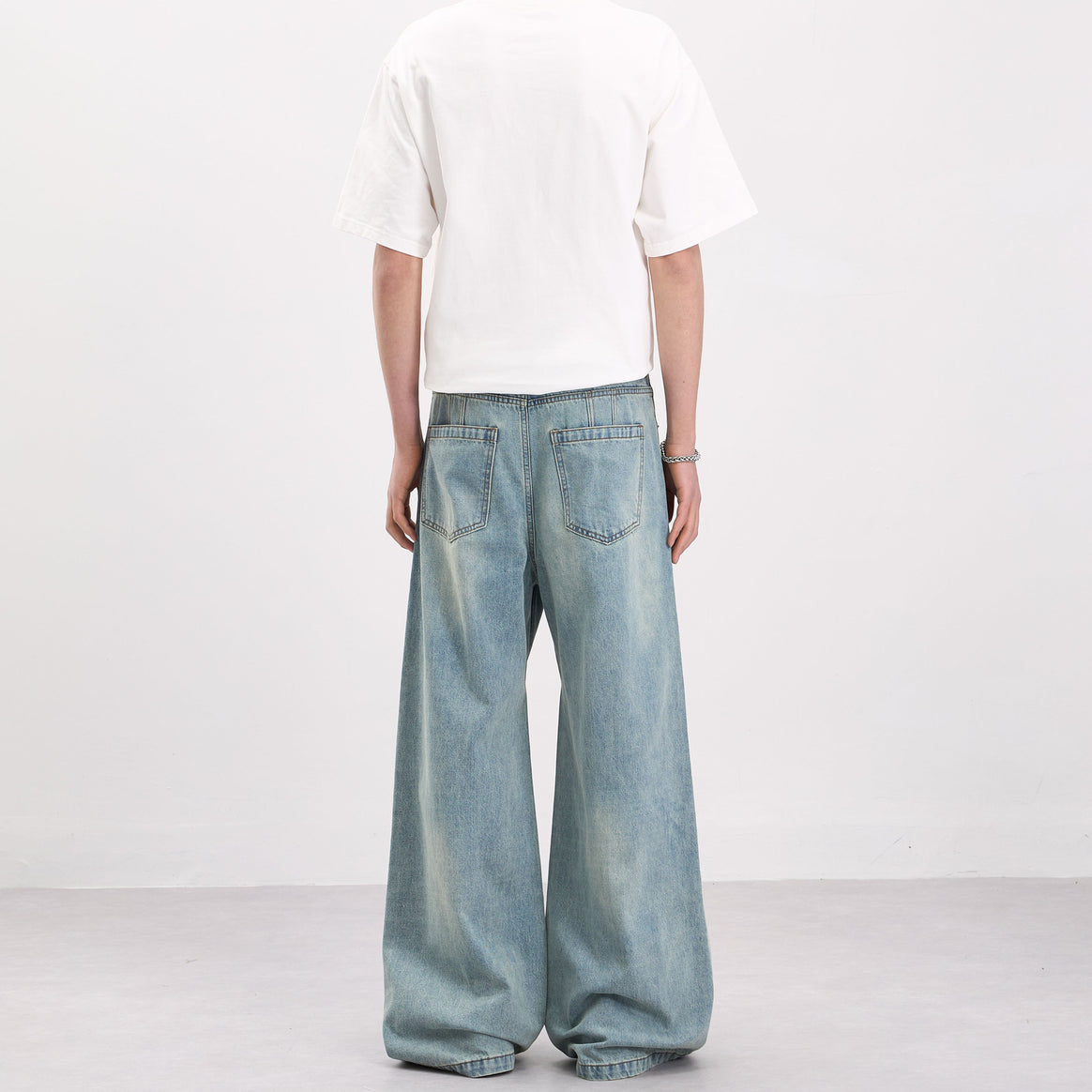 Men's wide-cut denim palazzo pants with curved seam panels and extra-long hem Mune Fashion