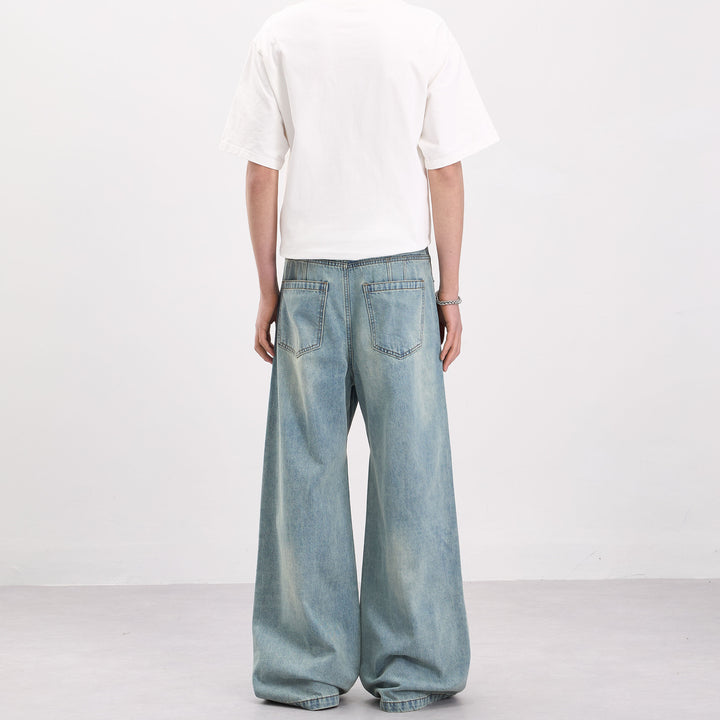 Men's wide-cut denim palazzo pants with curved seam panels and extra-long hem Mune Fashion