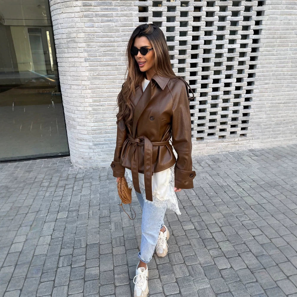 Women’s short cut oversized faux leather trench coat with waist belt and epaulettes Mune Fashion