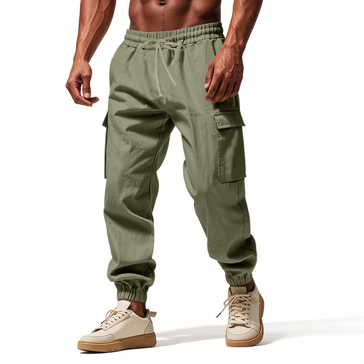Men's tapered joggers in utilitarian style with elastic waistband, drawstring, and flap pockets Mune Fashion