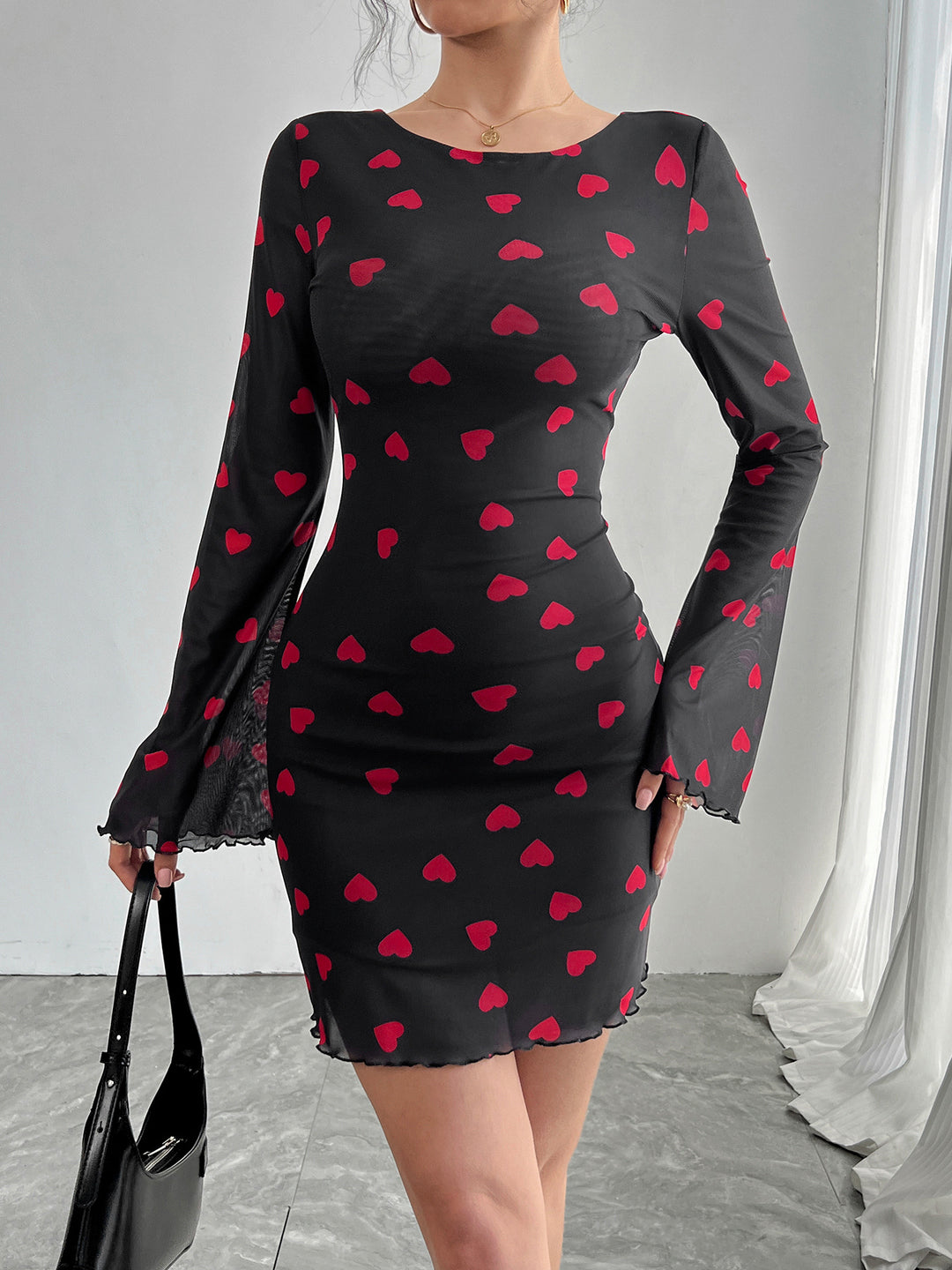 Women's figure-hugging mini dress made of fine mesh fabric with heart pattern and trumpet sleeves Mune Fashion