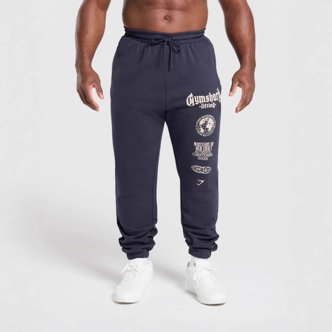 Men's tapered cotton fleece sweatpants with an elastic drawstring waistband, ribbed leg openings, and large logo print Mune Fashion