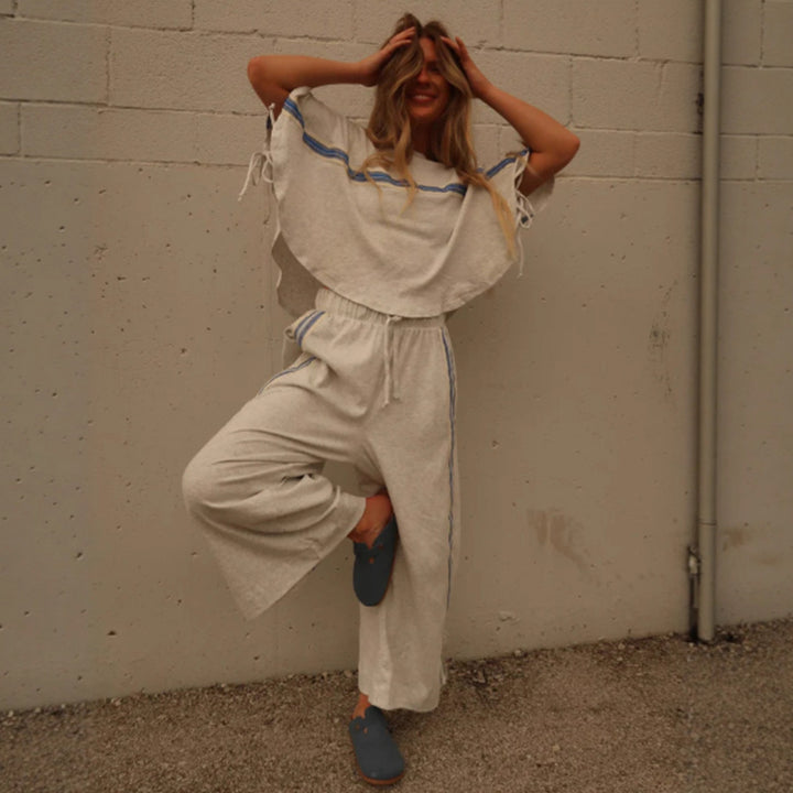 Ladies two-piece leisure ensemble with boxy ruffle top and wide cord pants with side decorative stripe Mune Fashion