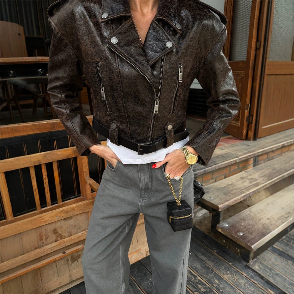 Women short cut biker jacket made of textured faux leather with waist belt Mune Fashion