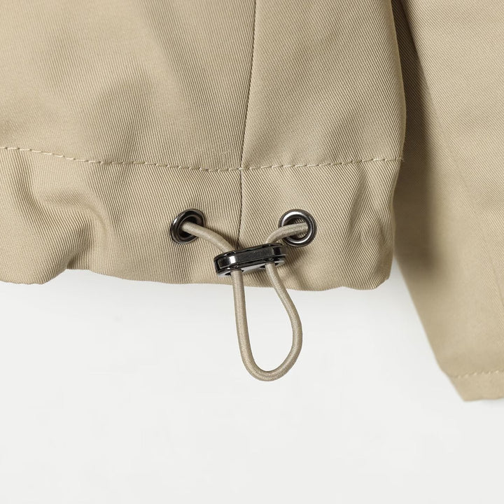 Women's reversible lightweight transitional jacket with stand-up collar, raglan sleeves, and drawstring hem Mune Fashion