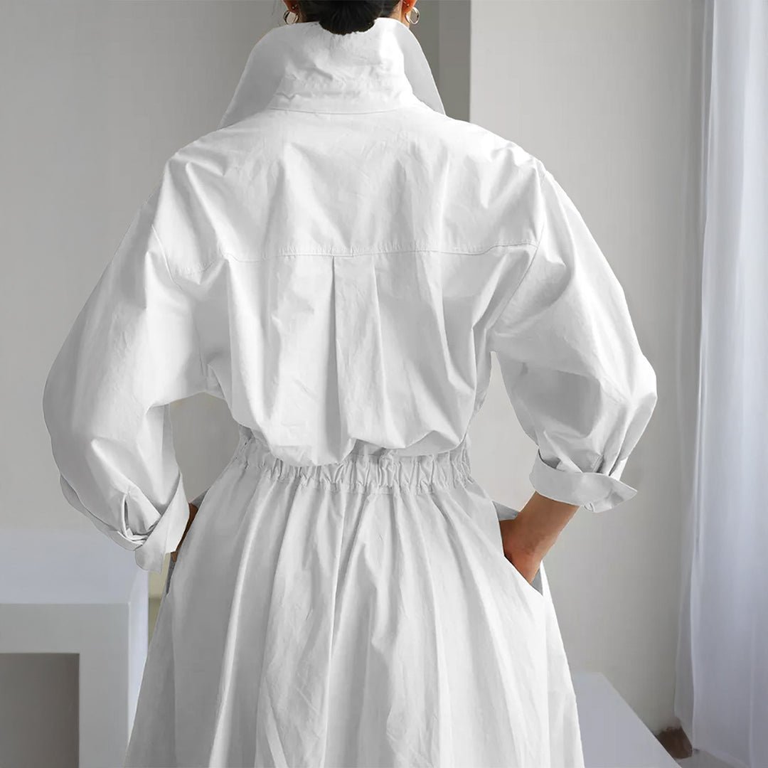 Women's tailored shirt dress with boxy collar, mid-length sleeves, side pockets, and flared pleated skirt Mune Fashion