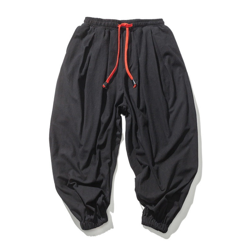 Men's wide-cut harem pants with low crotch, elastic waistband, and decorative drawstring Mune Fashion