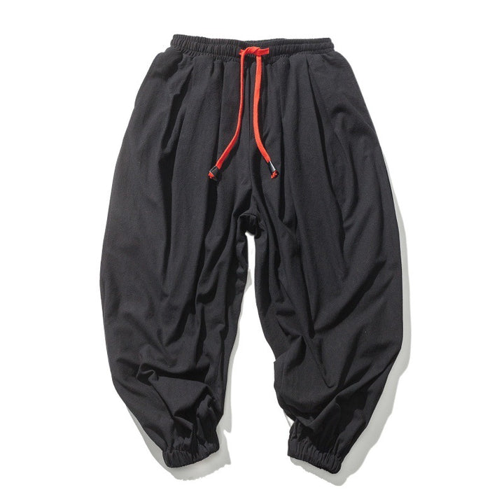 Men's wide-cut harem pants with low crotch, elastic waistband, and decorative drawstring Mune Fashion
