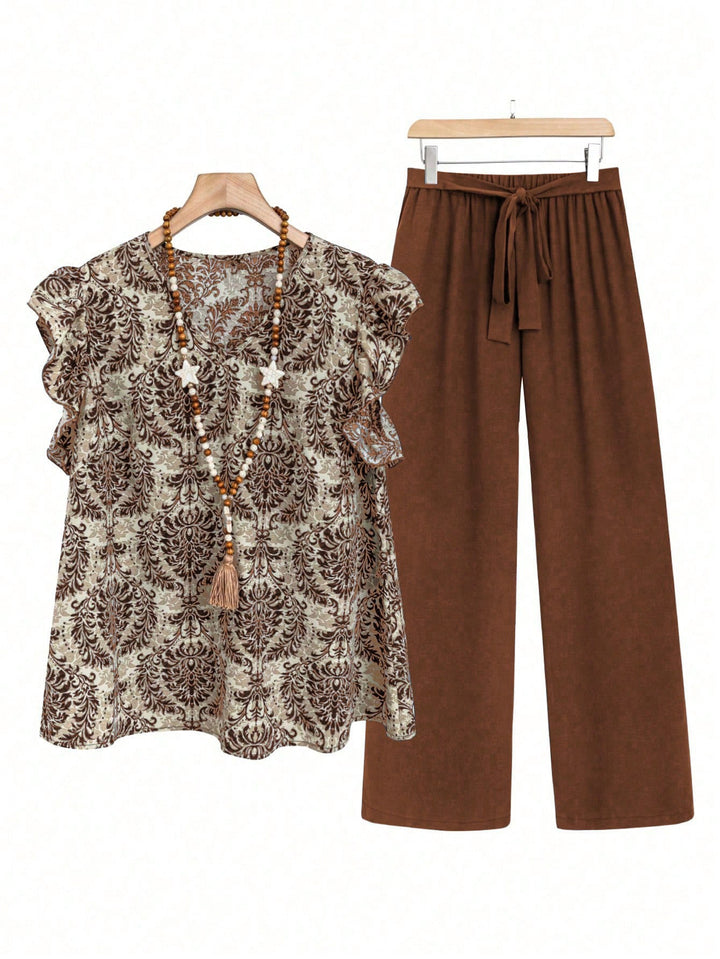 Women's two-piece ensemble with ruffled print blouse and wide waist trousers model Mune Fashion