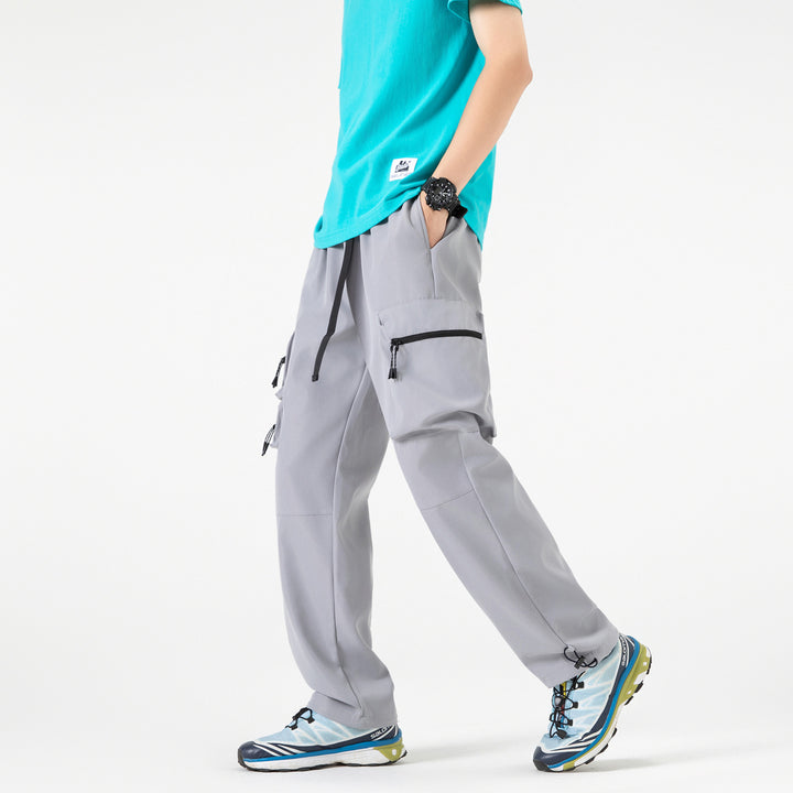 Men's loose technical cargo pants with multi-functional pockets, drawstring waistband, and adjustable leg closures Drune