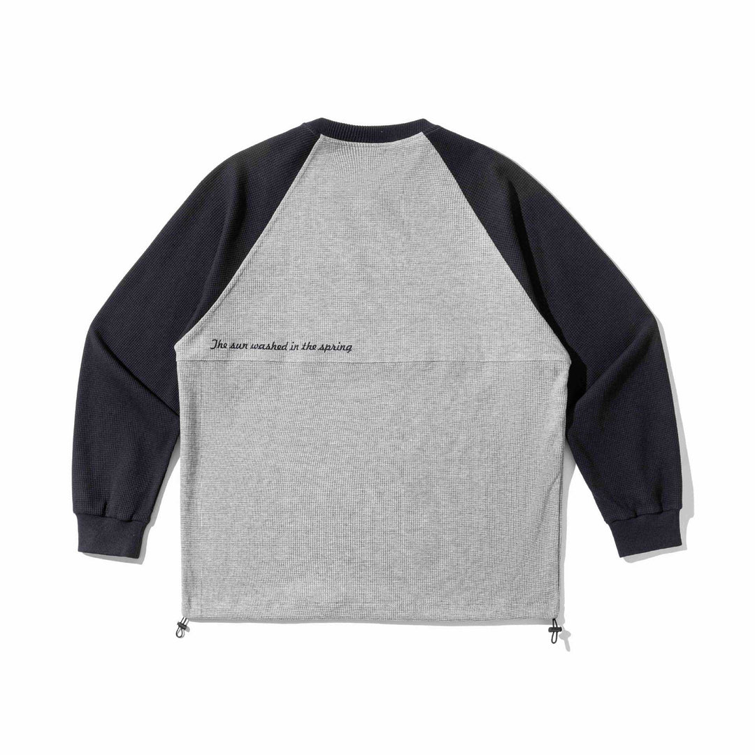 Unisex Raglan sweatshirt with thermo waffle texture, drawstring hem and subtle chest embroidery Mune Fashion