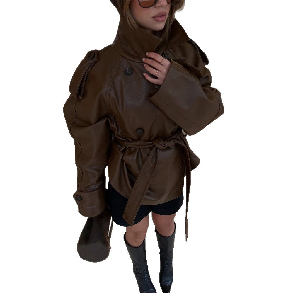 Women’s short cut oversized faux leather trench coat with waist belt and epaulettes Mune Fashion