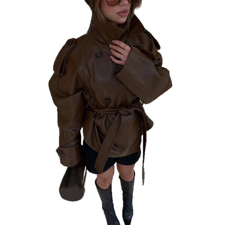 Women’s short cut oversized faux leather trench coat with waist belt and epaulettes Mune Fashion