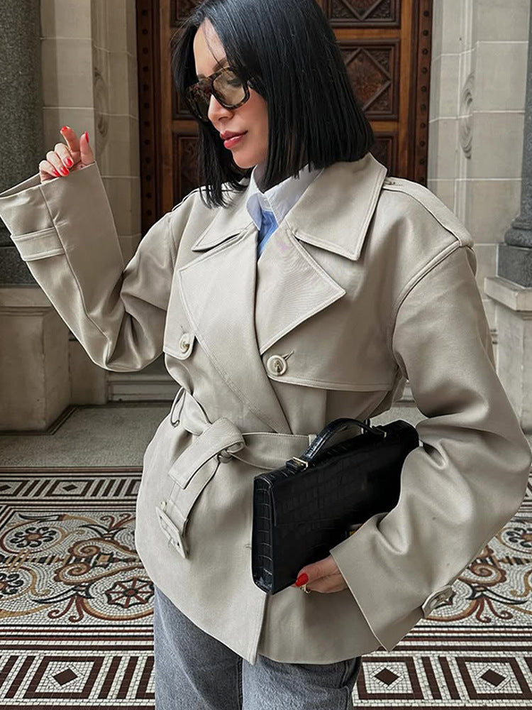 Women's short trench-style jacket with a tailored tie belt and wide sleeves Mune Fashion